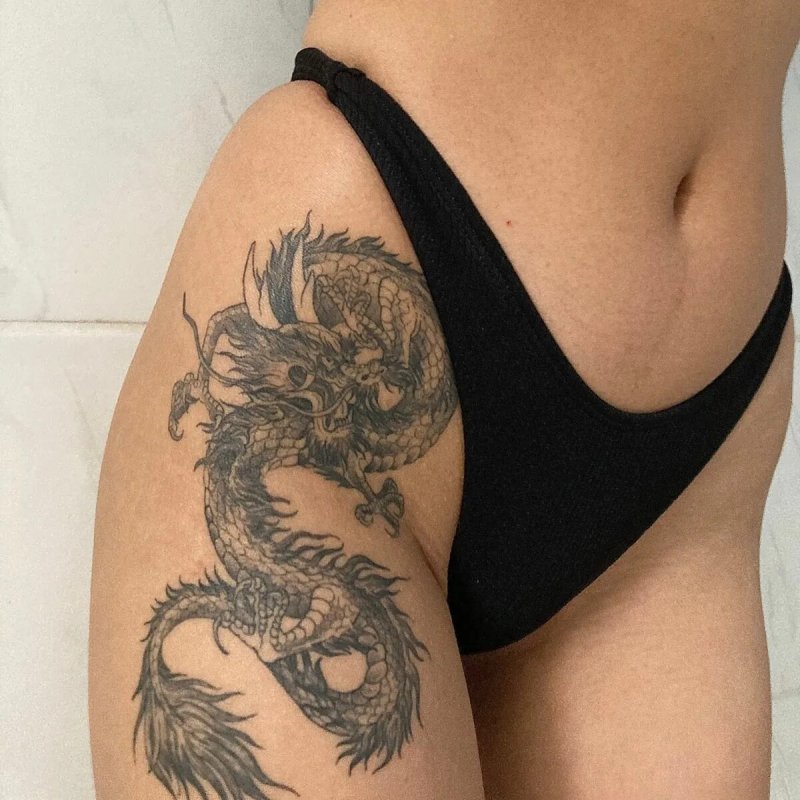 Тату дракона на бедре